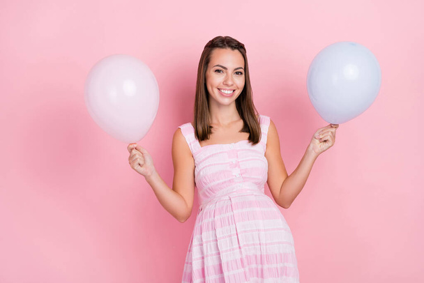 Photo of cheerful young nice woman hold hands balloons enjoy party celebrate cool isolated on pink color background - 写真・画像