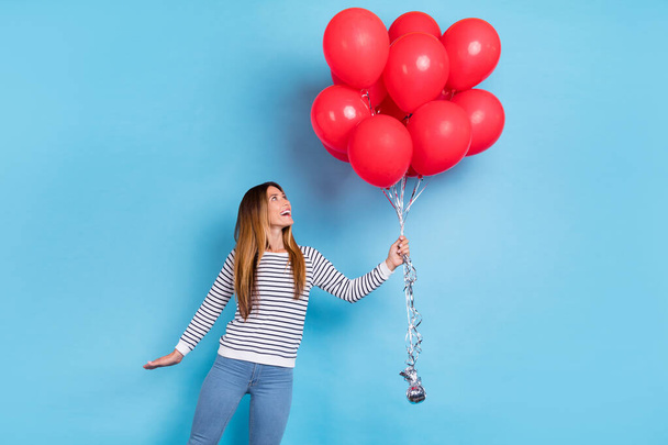 Photo of young blond impressed lady look balloons wear white shirt isolated on blue color background - Foto, Imagem