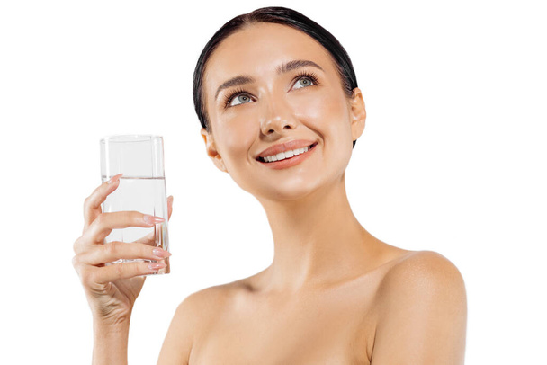 Healthy lifestyle. happy smiling young woman with a glass of fresh water, woman holding a glass of water on an isolated white background, Health care. Beverages. Diet Concept. Healthy eating - 写真・画像