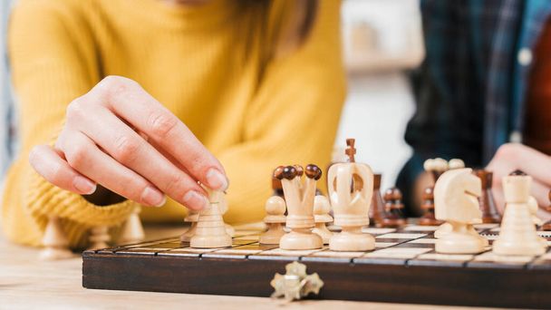close up young woman playing chess board game. High quality photo - Foto, Bild