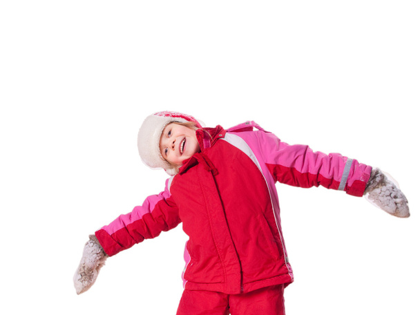 The laughing girl wearing red overalls and mittens with snow - Valokuva, kuva