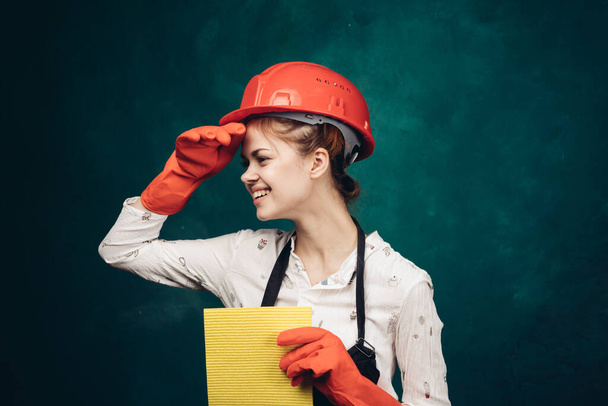 woman in black apron orange hard hat protection cleaning - Photo, Image