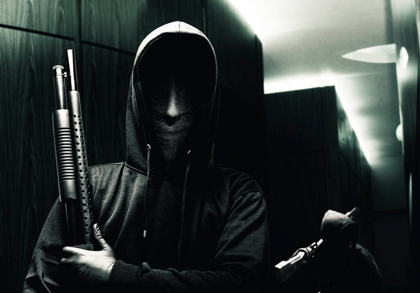 Group of criminal men in a hidden mask with a shotgun robbery the house - Fotó, kép