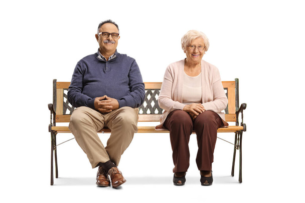 Elderly man and woman in casual clothes sitting on a bench isolated on white background - Foto, imagen