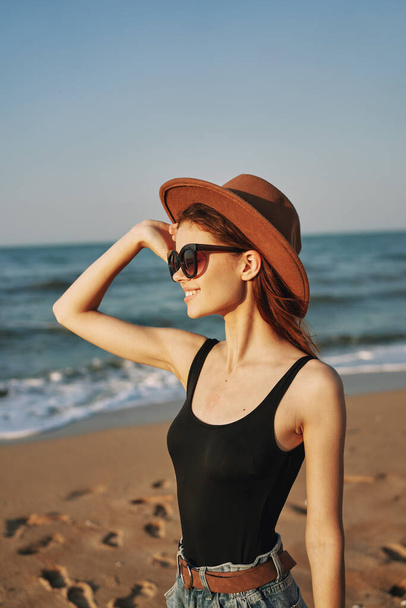 pretty woman in hat and sunglasses on the beach walk sun - Фото, изображение
