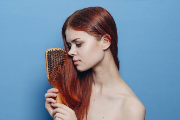 pretty woman combing hair bare shoulders hair care - Foto, Imagem