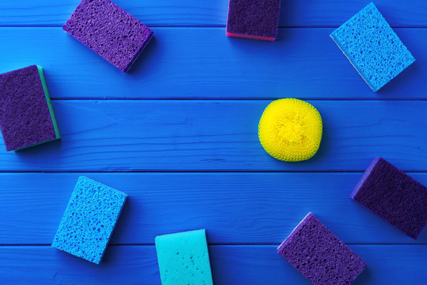 Cleaning sponges on blue wooden background flat lay - Fotó, kép