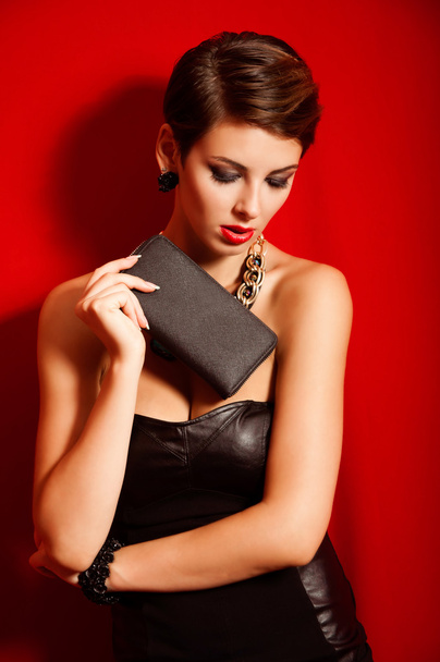 Beautiful girl with a  clutch bag - Photo, Image
