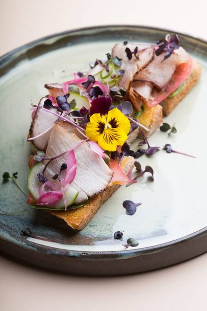 Ham toast bruschetta decorated with flowers and micro green - Foto, immagini