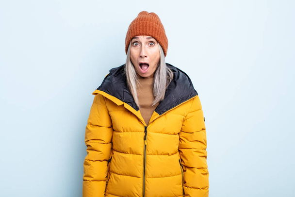 middle age gray hair woman looking very shocked or surprised. cold weather concept - Фото, зображення