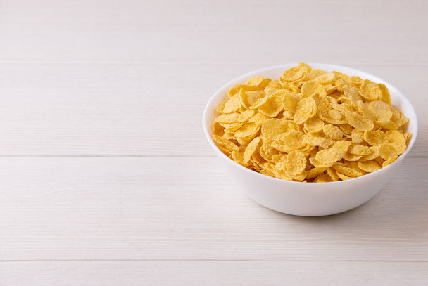 cornflakes with milk in bowl on table, closeup - Fotoğraf, Görsel