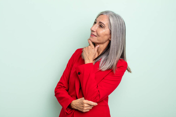 middle age gray hair woman smiling with a happy, confident expression with hand on chin. senior businesswoman concept - Zdjęcie, obraz