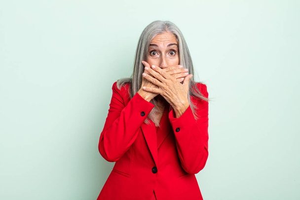 middle age gray hair woman covering mouth with hands with a shocked. senior businesswoman concept - Фото, зображення