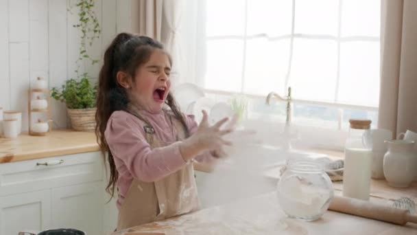 Roztomilé arabské holčička baví s moukou v kuchyni - Záběry, video