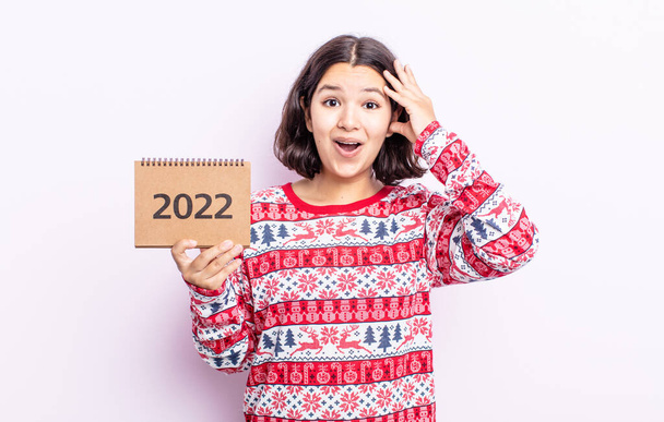 pretty young woman looking happy, astonished and surprised. 2022 calendar concept - Valokuva, kuva