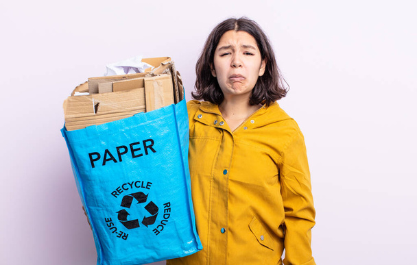 pretty young woman feeling sad and whiney with an unhappy look and crying. paper recycle concept - Fotó, kép