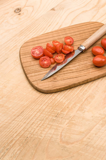 datterini tomatoes with chopping board and knife on a wooden surface with text space - Foto, Bild