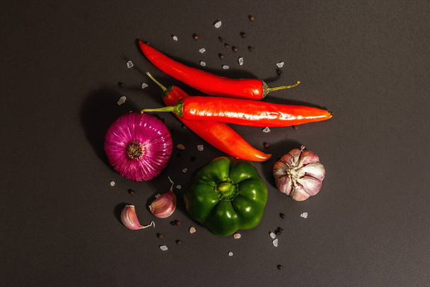 Cooking background. Set of fresh vegetables on black stone background. Collection of colorful products, flat lay, trendy hard light, dark shadow, top view - 写真・画像