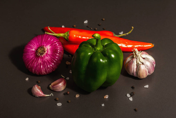 Cooking background. Set of fresh vegetables on black stone background. Collection of colorful products, flat lay, trendy hard light, dark shadow, close up - Photo, Image