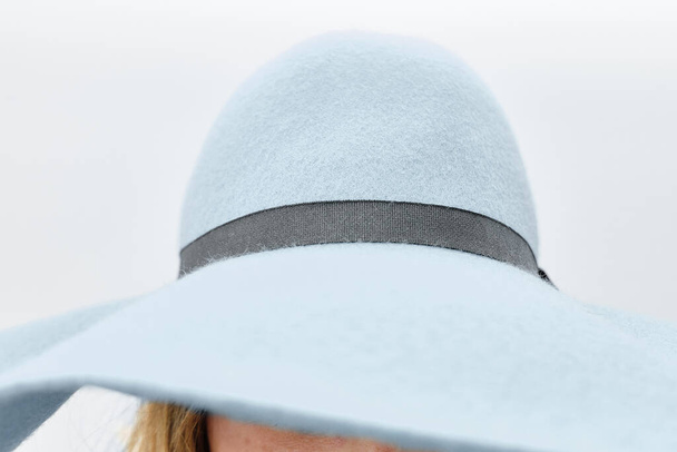A closeup shot of a woman's light blue floppy hat with a grey ribbon - Fotoğraf, Görsel