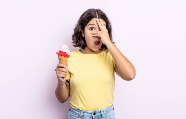 pretty young woman looking shocked, scared or terrified, covering face with hand. ice cream concept - Fotoğraf, Görsel