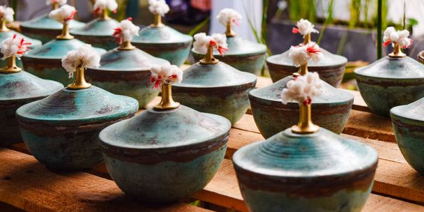 Beautiful pottery with lids on the wooden table - Foto, Imagem