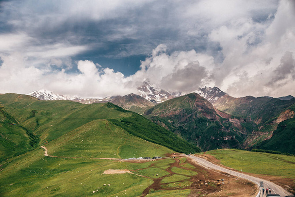 An aerial view of the green beautiful mountains under the cloudy stormy sky in Georgia - Foto, immagini