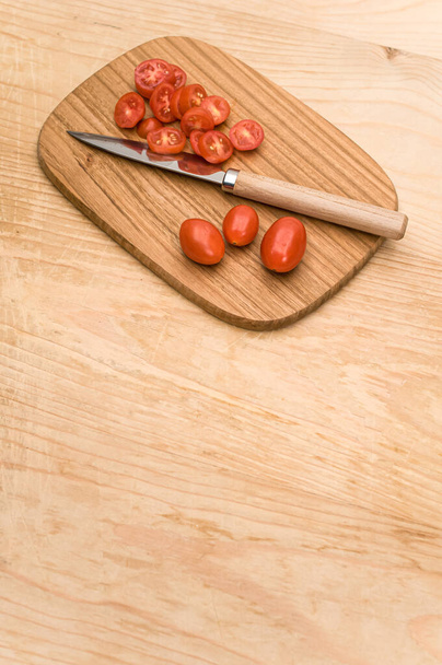 datterini tomatoes with chopping board and knife on a wooden surface with text space - Foto, Imagem