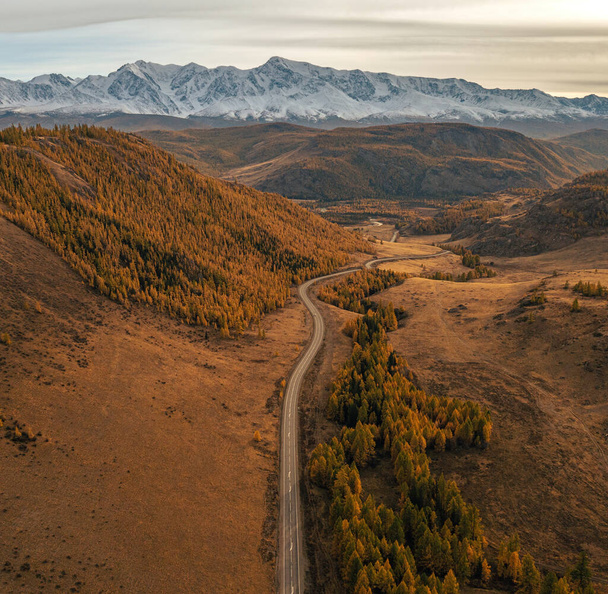 An aerial view of a highway between mountains - Foto, afbeelding