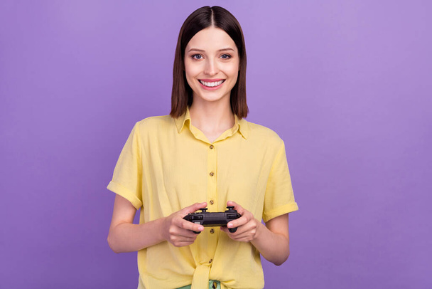 Photo of young lovely lady have fun play video game console free-time isolated over violet color background - Foto, afbeelding