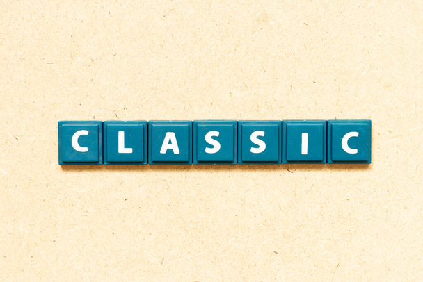 Tile alphabet letter in word classic on wood background - Foto, Bild
