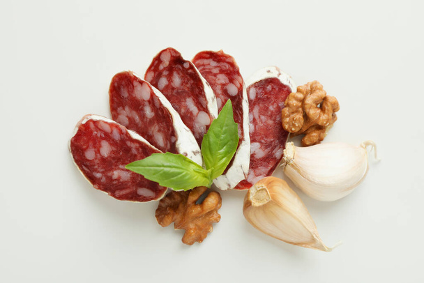 Concept of tasty food with salami sausage isolated on white background - Photo, Image