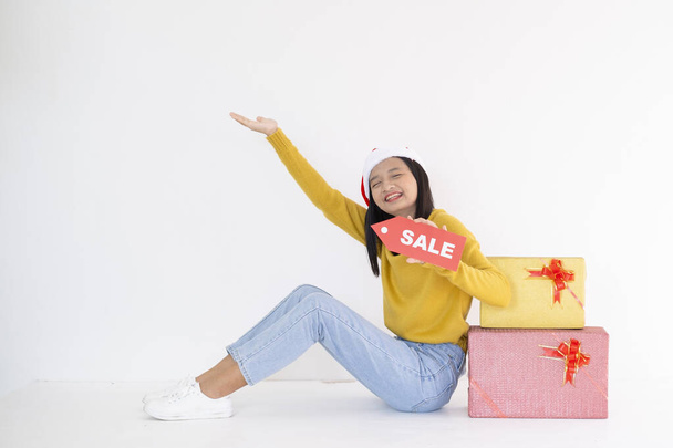 Happy young girl hold present box , Asian girl wear yellow sweater on white background. - Valokuva, kuva