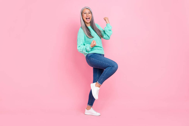 Photo of cool white hairdo old lady yell wear eyewear teal pullover jeans sneakers isolated on pink color background - Photo, image