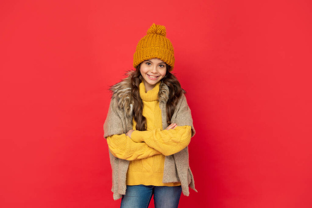 express positive emotion. winter fashion. happy kid with curly hair in hat crossed hands. - Photo, image