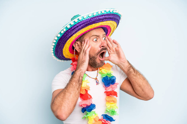 middle age man feeling happy, excited and surprised. mexican culture - 写真・画像