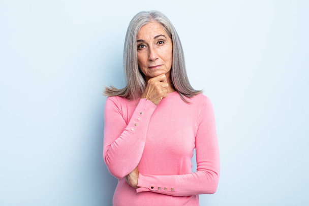 middle age gray hair woman looking serious, confused, uncertain and thoughtful, doubting among options or choices - Foto, imagen