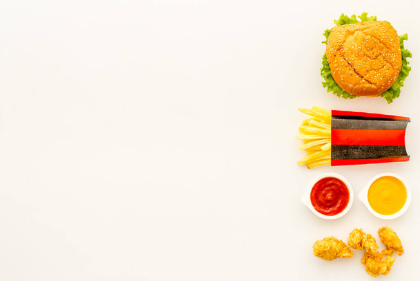 Junk food with hamburger chicken nuggets and french fries - 写真・画像