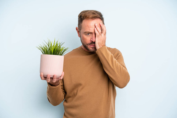 middle age man feeling bored, frustrated and sleepy after a tiresome. plant pot concept - Фото, зображення