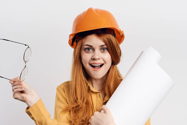 female engineer in orange hard hat blueprints architect - Фото, изображение