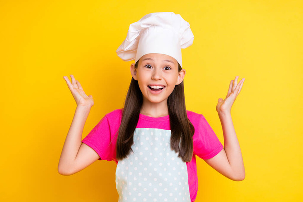 Photo of amazed funny girl omg nutrition ingredient reaction wear white apron hat isolated yellow color background - Photo, Image
