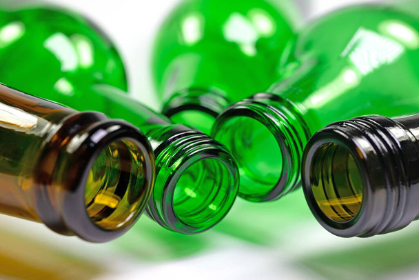 Empty glass bottles in the colors green and brown - Photo, image