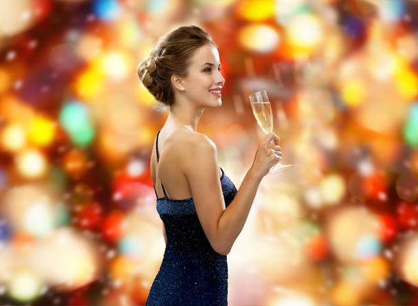 smiling woman holding glass of sparkling wine - Foto, imagen