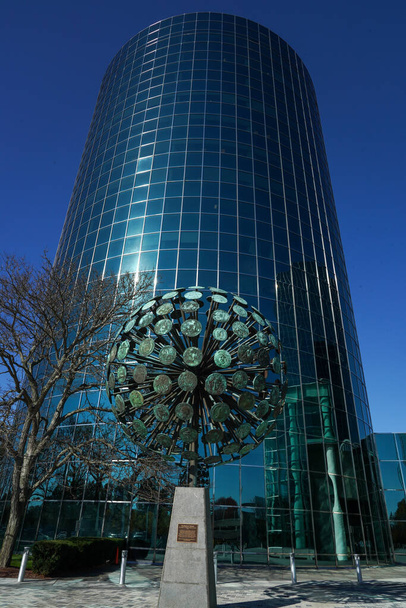UNIONDALE, NEW YORK - NOVEMBER 8, 2021: Numismatic Sphere by Dorothy Cooper and Harold Caster in Uniondale. At 20 feet tall and weighing 7 tons bronze sphere represents 182 coins from around the world - Photo, image