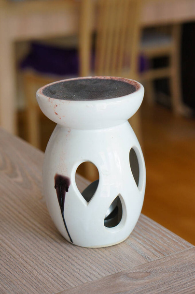 A closeup n aroma lamp with tear-shaped holes - Foto, afbeelding