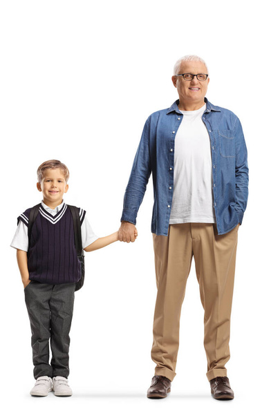 Full length portrait of a father holding his son by the hand isolated on white background - Φωτογραφία, εικόνα