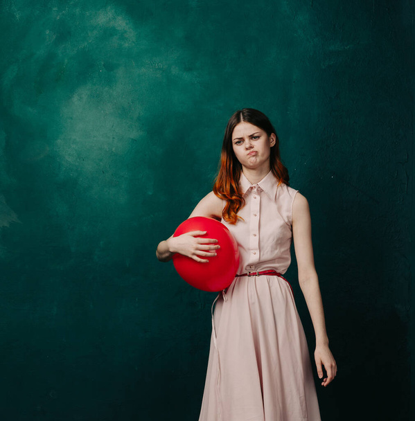 woman with red balloon celebration birthday green background - 写真・画像