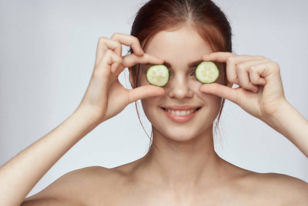 cheerful woman with cucumbers bare shoulders skin care cosmetology - Fotoğraf, Görsel