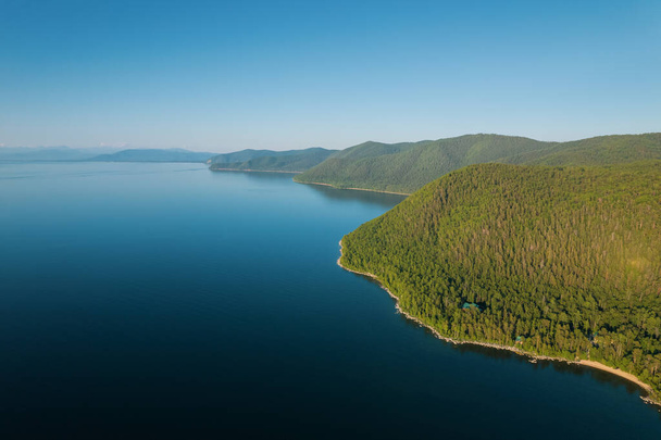 Summertime imagery of Lake Baikal is a rift lake located in southern Siberia, Russia Baikal lake summer landscape view from a cliff near Grandmas Bay. Drones Eye View. - Photo, Image