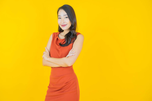 Portrait beautiful young asian woman smile with action on color background - Foto, afbeelding